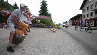 Spectators ring cow bells and play alpine horns (or Swiss Alphorns) during Stage 8. AFP