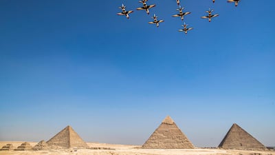 They fly above (R to L) the Great Pyramid of Khufu, the Pyramid of Khafre and the Pyramid of Menkaure. AFP