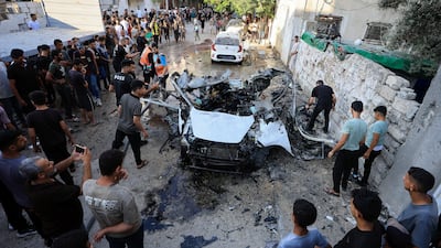 Palestinians at the scene of an Israeli strike on a vehicle in Gaza city. Reuters