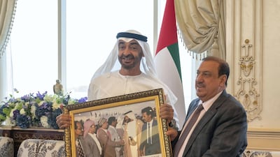 Sheikh Mohamed bin Zayed, Crown Prince of Abu Dhabi and Deputy Supreme Commander of the UAE Armed Forces, receives a gift of a framed photograph from Sultan Al Burkani, Speaker of the Yemeni Parliament, during a Sea Palace barza. Mohamed Al Hammadi / Ministry of Presidential Affairs