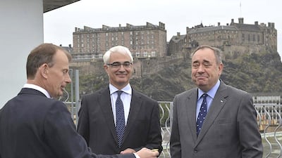 Alistair Darling, centre, the leader of the campaign to keep Scotland part of the United Kingdom, and Scottish first minister Alex Salmond, right, watch as Andrew Marr prepares to toss a coin on the BBC's Andrew Marr Show in Edinburgh. Jeff Overs / BBC / Handout via Reuters