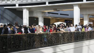 Shoppers wait patiently for their first look inside the store. Sarah Dea / The National