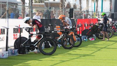 Participants change for the running section of the race. Leslie Pableo for The National