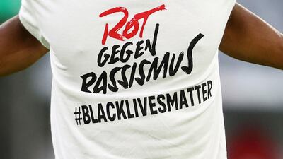Kingsley Coman of Bayern Munich wears a shirt to warm up in with a message in support of the Black Lives Matter campaign. Getty