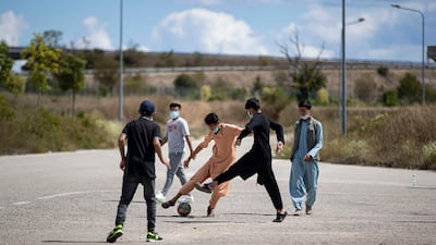 Afghan youth play football at a reception centre for Afghan refugees organised by the Italian Red Cross in Avezzano, Italy. Italy is hosting almost 5,000 Afghan refugees who were flown from Kabul after the Taliban claimed control of the capital. EPA