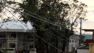 Fallen power lines dangle over buildings after Typhoon Phanfone swept through Tanauan, Leyte, in the Philippines. Reuters