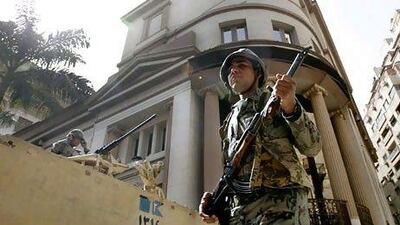 Soldiers guard the Cairo stock exchange, which has been closed for a month. The bourse will reopen today.