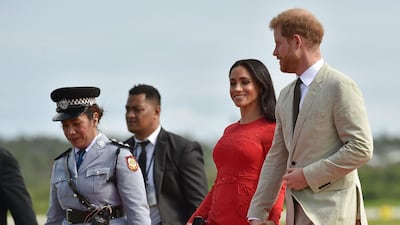 Britain's Prince Harry and his wife Meghan Markle, the Duchess of Sussex arrive at Fua'amotu airport in Tonga.. AFP