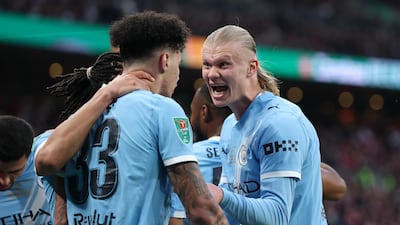 Nico O'Reilly celebrates scoring with Erling Haaland. Getty Images