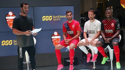 Al Ahli's Majed Hassan, left, Everton Ribeiro and Ismail Al Hammadi were on hand to help the team launch their new kit in Dubai on Sunday. Hasan Alraesi / Al Ittihad