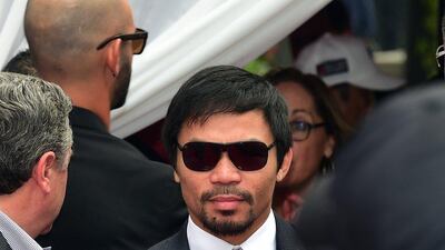 Boxer Manny Pacquiao arrives on Wednesday at the press conference in Los Angeles for his May 2 fight with Floyd Mayweather. Frederic J Brown / AFP