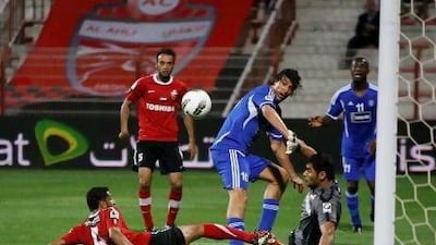 Al Ahli keeper Yousif Abdulla, on the ground at right, stops a shot on goal by Al Nasr's Luca Toni.