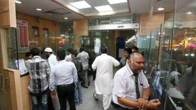 Expatriates transfer money at an exchange shop in Dubai last week.