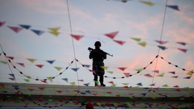 A policeman stands guard on the roof of the Karte Sakhi Shrine as Shiite muslims held a religious ceremony in Kabul, Afghanistan. Farshad Usyan / AFP