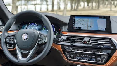 The Alpina B5's interior is full of luxury touches, from plentiful wood trim to Nappa leather seats. Khushnum Bhandari for The National
