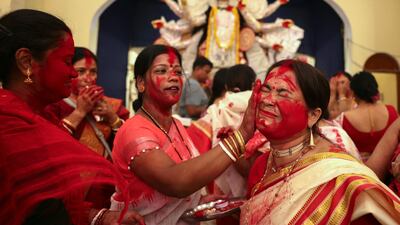 Devotees take part in the 'Sindoor Khela' ritual, in which married women anoint each other with vermilion powder, in Varanasi, India. AFP