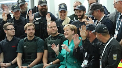 German chancellor Angela Merkel sits with members of law enforcement and emergency services while thanking them at the conclusion of the G20 economic summit on July 8, 2017 in Hamburg, Germany. Severe rioting by anti-G20 activists that included looting, arson and attacks on police overshadowed the two-day summit. Sean Gallup / Getty Images