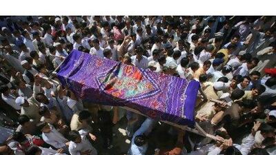 Mourners carry the coffin of a man was killed in a shootout by unidentified gunmen a day earlier, for his burial in Quetta yesterday. Gunmen opened fire on a bus in Baluchistan in a suspected sectarian attack on Tuesday, killing at least 26 Shiite Muslim pilgrims travelling to Iran, police said. Naseer Ahmed / Reuters
