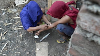 Young Indian drug addicts use heroin in an abandoned building in the Punjab city of Jalandhar in this June 15, 2016 picture. Shammi Mehra / AFP