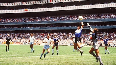 Diego Maradona punches the ball past Peter Shilton of England to score the opening goal of the World Cup Quarter Final at the Azteca Stadium in Mexico City in 1986. Photo: Bongarts