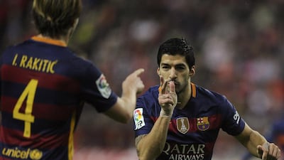 Barcelona’s Luis Suarez celebrates after scoring a goal with team mate Ivan Rakitic. REUTERS/Eloy Alonso