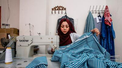 Checking the cloth for flaws is a crucial part of the process. AFP