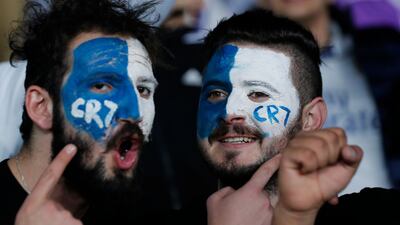 Fans of Real Madrid's Cristiano Ronaldo show their support from the stands. Hassan Ammar / AP Photo