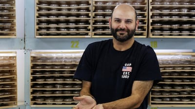 Jassem Buabbas with a handful of 'superworms' at his farm in Kabad, 50km north-west of Kuwait City. AFP