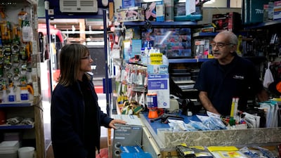 Sarah Edmiston, the company Administration Manager, chats with her colleague store employee Martin Matio at a branch of the Tool Shop hardware stores in the Bayswater area of central London. AP Photo