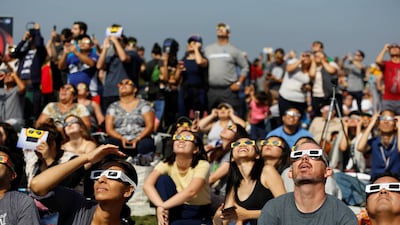 People watch the solar eclipse on the lawn of Griffith Observatory in Los Angeles, California. Mario Anzuoni / Reuters