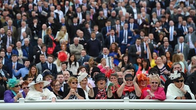 Punters cheer on the riders in the Betford Melling Steeple Chase at Aintree Racecourse on Friday in Liverpool, England. Laurence Griffiths / Getty Images / April 4, 2014