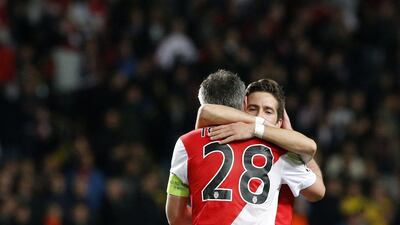 Joao Moutinho, right, of AS Monaco celebrates with teammate Jeremy Toulalan on Tuesday as they advanced to the Champions League quarter-finals despite a 2-0 loss to Arsenal. Sebastien Nogier / EPA