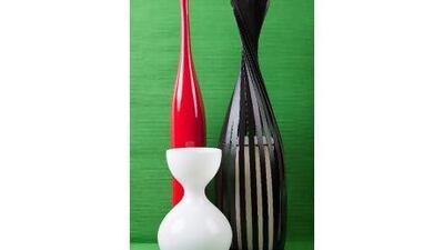 Red vase, Dh 329 at ID Design, black candle holder, Dh149 at The One, pillar candle, Dh39 at The One, white vase, Dh75 at @Home, green runner (as background), Dh69 at Zara Home.