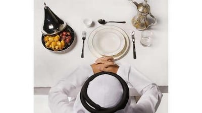 A man prays before breaking his fast. Typically, the Ramadan fast is broken with water and dates before a feast of traditional food is served.