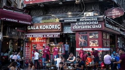 Customers wait outside a restaurant in Istanbul. The lira has weakened 35 per cent against the dollar this year (Photo by Chris McGrath/Getty Images)