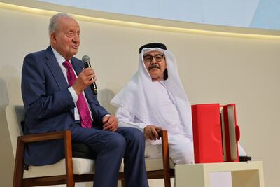 Former Spanish king Juan Carlos, left, speaks beside Emirati writer and filmmaker Nasser Al Dhaheri during the Arabic launch of Reconciliation at Abu Dhabi Book Fair. Zoran Mircetic / Abu Dhabi Arabic Language Centre