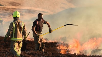 Firefighters tackle a blaze on moorland above Marsden, northwest England. AFP