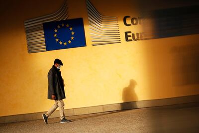 A mans shadow falls onto the facade of EU headquarters in Brussels. AP