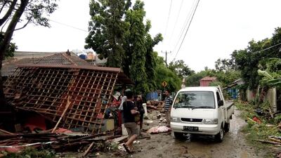 Residents inspect the damage to their homes on Carita beach. AFP