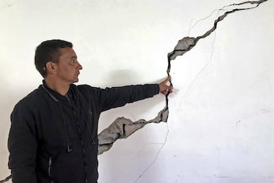 A Joshimath resident shows a crack on the wall of his house. AFP