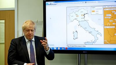 Britain's Prime Minister Boris Johnson gestures in front of a map of Italy in the command centre during a visit to the Public Health England National Infection Service in Colindale in north London on March 1, 2020. AFP / POOL