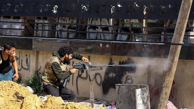 A Libyan fighter loyal to the Government of National Accord fires a machine gun at forces loyal to strongman Khalifa Haftar south of Tripoli, on April 10, 2019. AFP