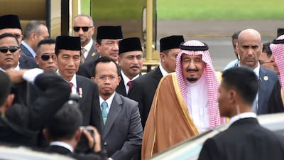 Indonesia's president Joko Widodo, centre left, welcomes Saudi Arabia's King Salman, centre right, at Halim airport in Jakarta. AFP