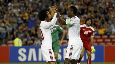 Omar Abdulrahman, left, congratulates Ahmed Khalil after the striker opened the scoring. Edgar Su / Reuters