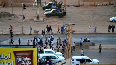 Members of Sudan's intelligence services shoot bullets in the air at the headquarters of the Directorate of General Intelligence Service. AFP
