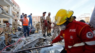 Iranian Red Crescent and rescue workers search the wreckage of a collapsed building in the city of Pole-Zahab. EPA/Abedin Taherkenareh
