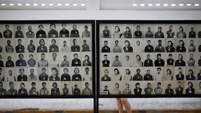 A visitor looks at pictures of victims of Khmer Rouge regime at the former notorious Tuol Sleng prison that is now the Genocide Museum, in Phnom Penh. A UN-backed tribunal on Thursday sentenced two top leaders of the former regime to life in prison for crimes against humanity on August 7. Damir Sagolj / Reuters