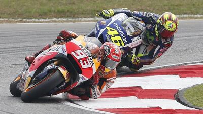 Honda MotoGP rider Marc Marquez, front, and Yamaha MotoGP rider Valentino Rossi ride during the Malaysian Motorcycle Grand Prix at Sepang International Circuit near Kuala Lumpur, Malaysia, October 25, 2015. REUTERS/Olivia Harris