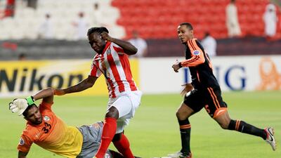 Al Jazira’s Felipe Caicedo, centre, gets past Al Shabab goalkeeper Mohammed Al Owais but is unable to find the net on Wednesday night in Abu Dhabi. Ravindranath K / The National