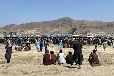 Hundreds of people gather near a US Air Force C-17 transport plane at Kabul airport in Afghanistan, during the US withdrawal in August 2021. AP